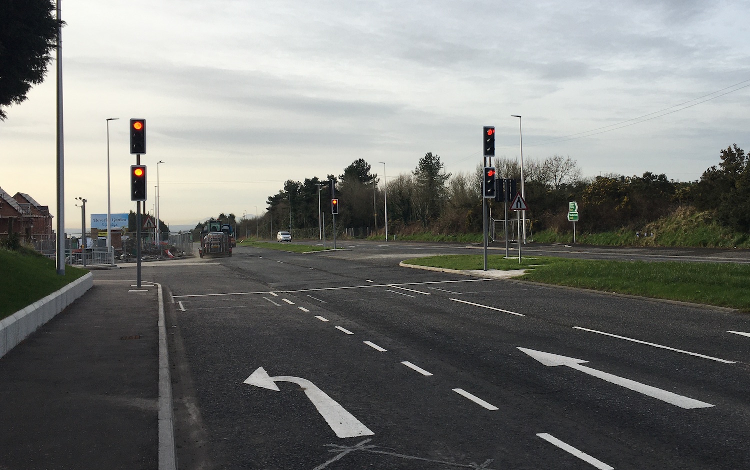 View along a road towards traffic signals
with two straight on lanes and one turn left
filter lane.