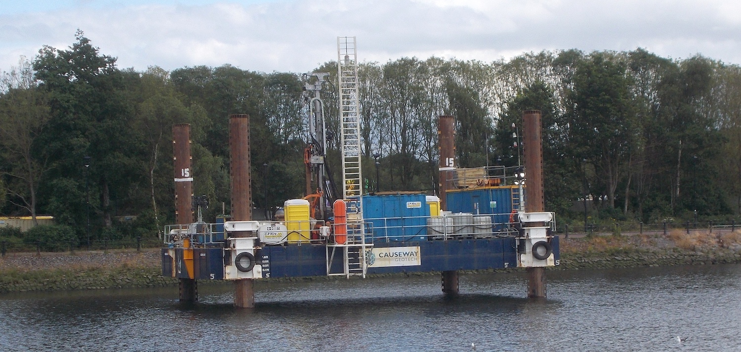 River Lagan with a large metal platform
about ten metres long held up on four metal
cylinders. On top is what looks like a
drilling derrick.