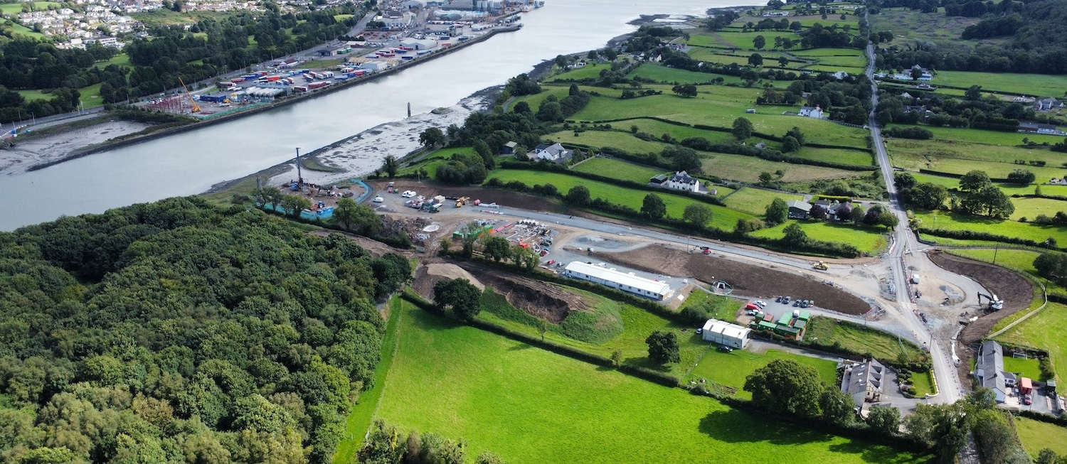 Newry river on left, building site
extending to the right with a new roundabout
taking shape on the right and a new road
heading left from it.
