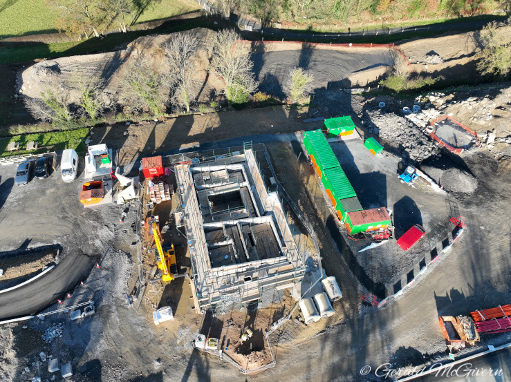 Looking down on a small concrete building
under construction, about a metre above ground
level.