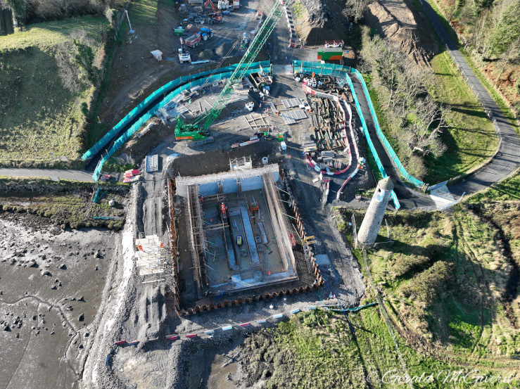 Looking down on a large square foundation
with lots of rebar and concrete visible.