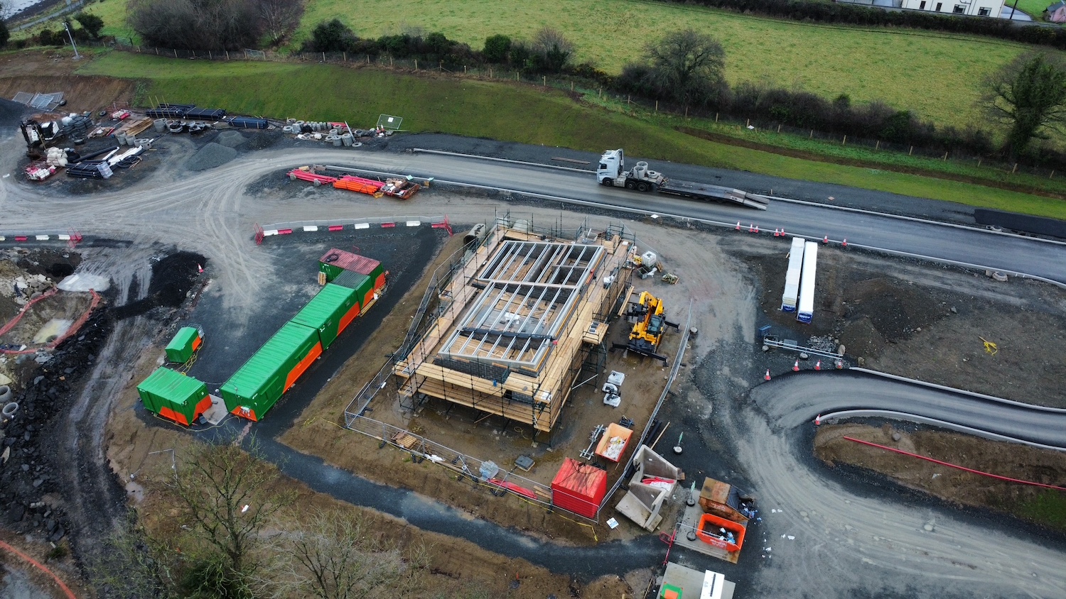 Building under construction seen from
above with work completed up to the rafter
level.