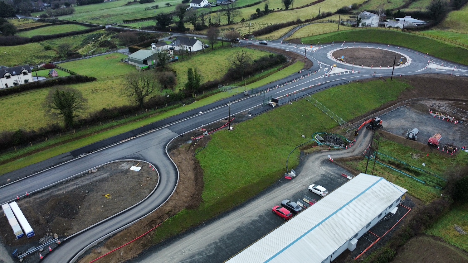 A roundabout at top left with a road
running to bottom left.