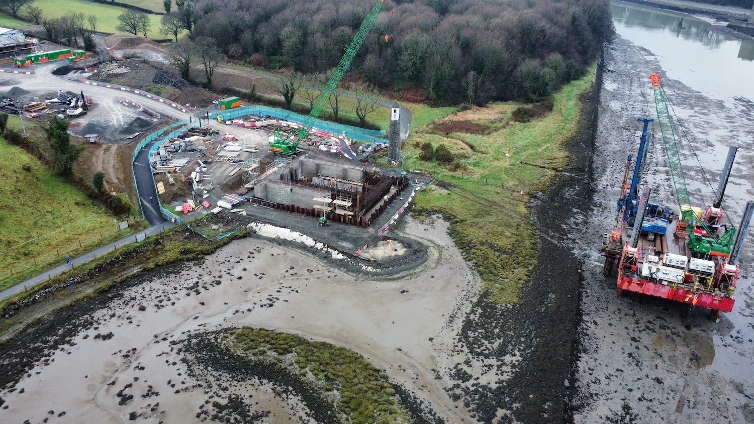 Foundations for bridge pier on left, with
a small area of mud and then a platform in the
water to the right.
