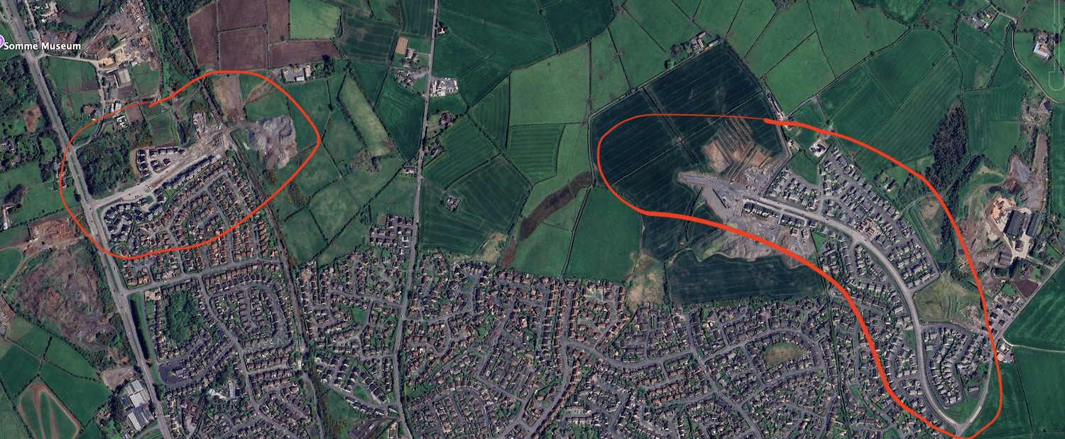 Aerial
view of Newtownards. A short length of new
road is visible on the left and a longer
stretch on the right. There are green fields
between them.